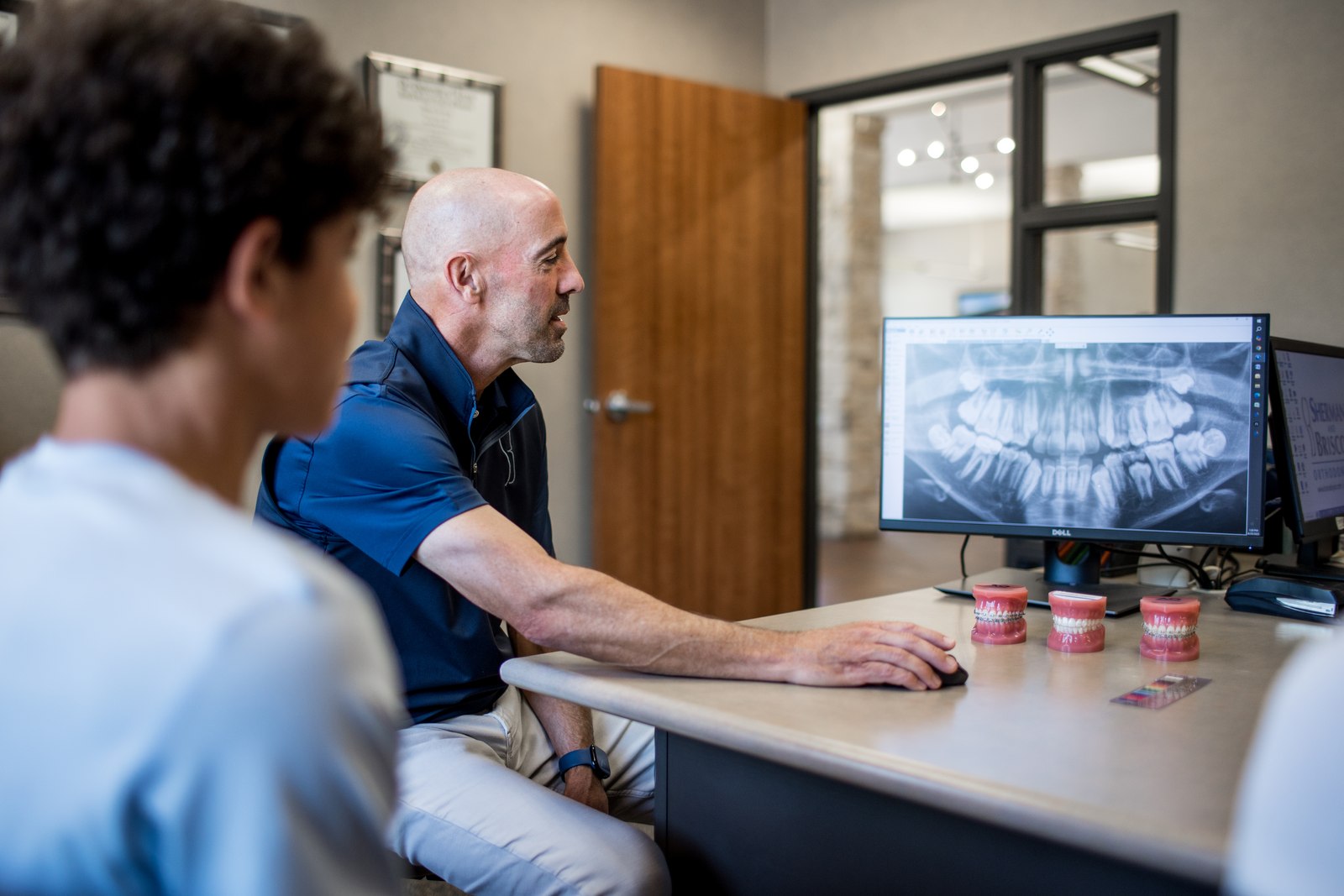 Dr. Sherman reviewing a panoramic X-ray with a patient.