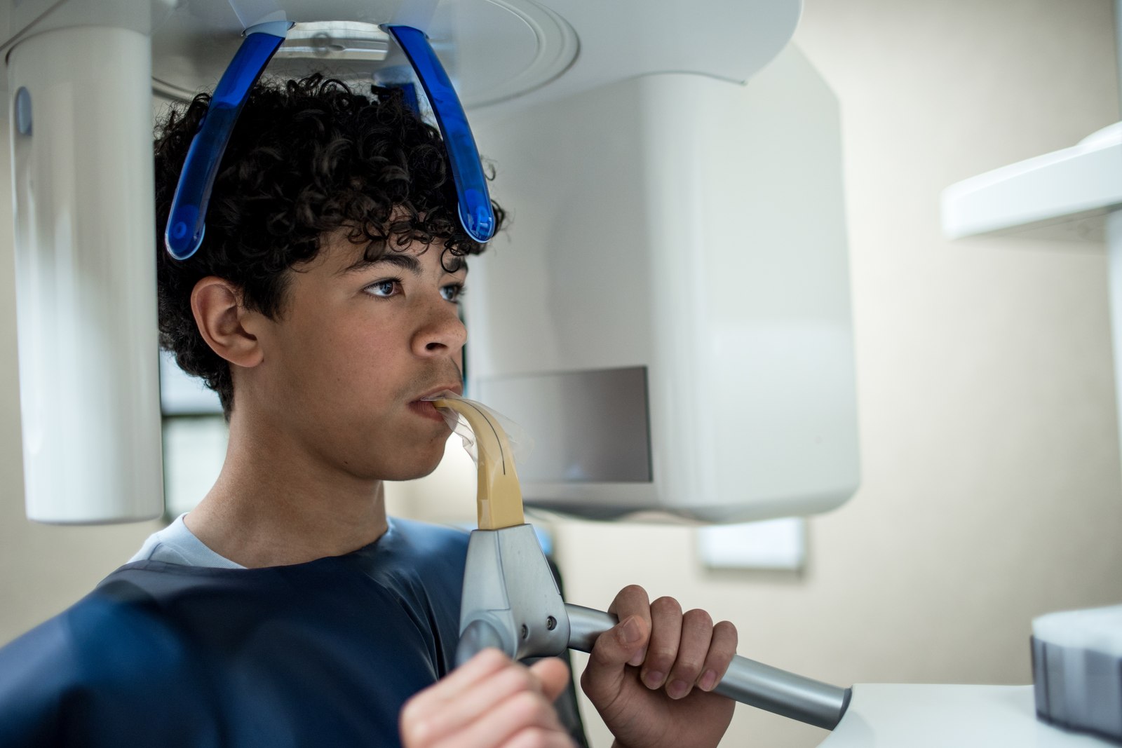 A patient positioned in the panoramic X-ray machine.