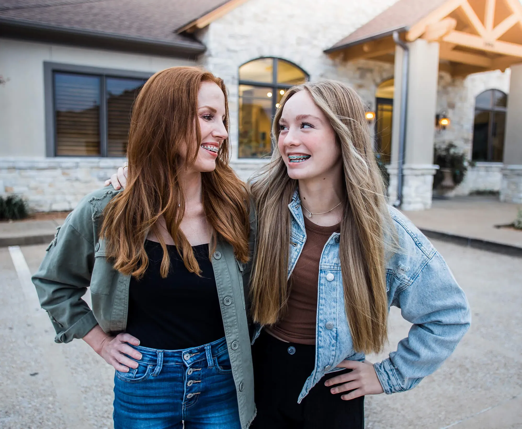Two family members smiling together outside a Sherman & Briscoe office.