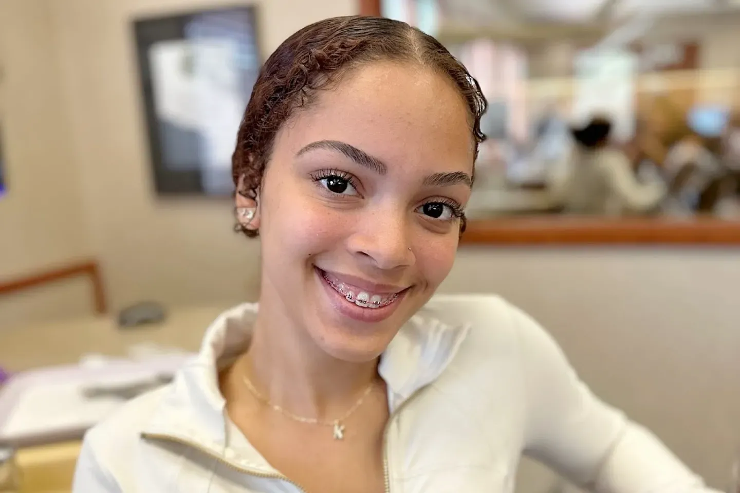 Patient with braces smiling in a Sherman & Briscoe office.