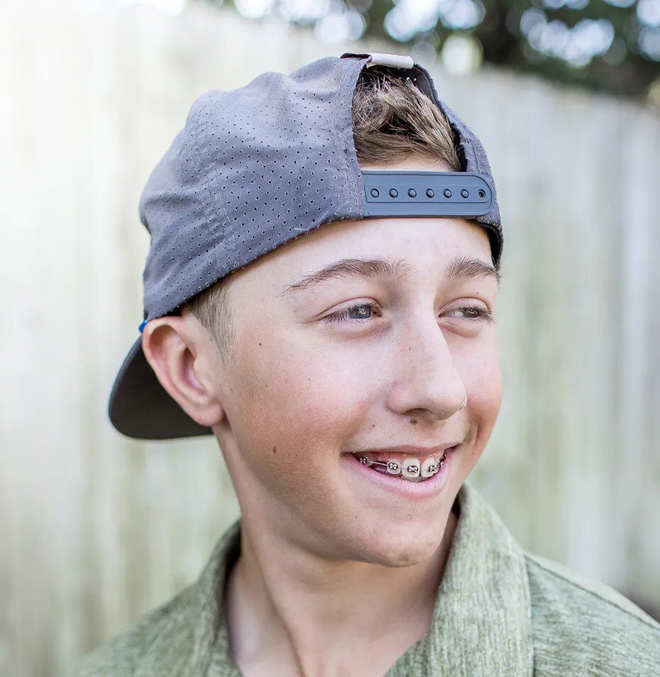 Patient smiling with contemporary metal braces.